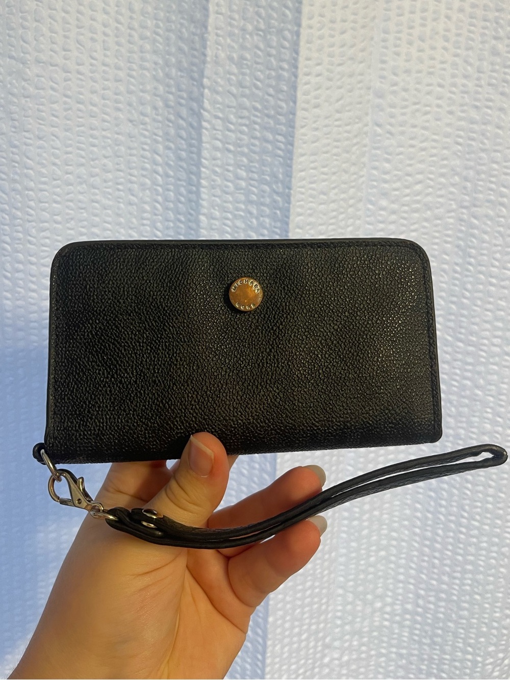 65. Michael Kors wristlet.